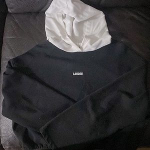 Zara black with white hood and “London”title in the middle